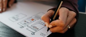 Designer drawing a web design idea on paper